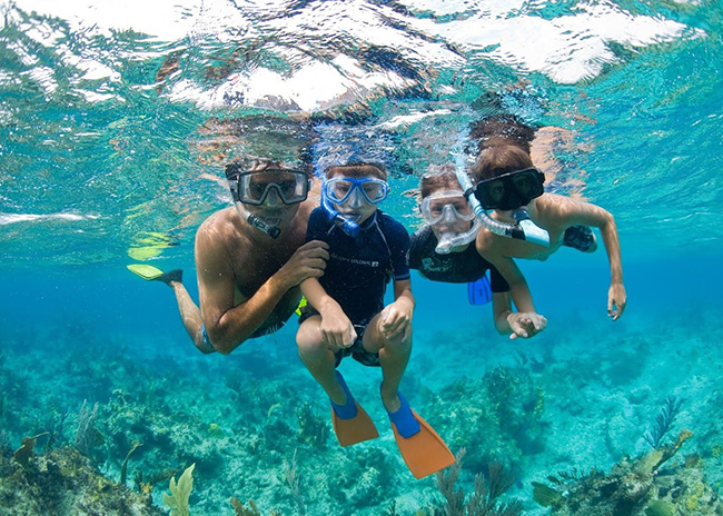Chrystal and her husband very happy to start a snorkeling tour with her son.